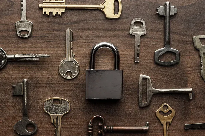 A picture of various keys and a padlock.